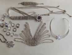An assortment of silver jewellery to include six neck chains, torc necklace, rings, pendants, etc