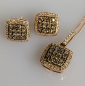 A 14ct rose gold pendant comprising prong-set round-cut cognac diamonds