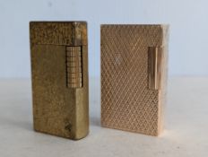 A vintage S. T. Dupont gold plated textured lighter in unopened plastic wrap, with original box