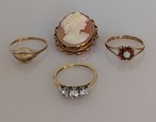 A three-stone diamond ring on an 18ct yellow gold and platinum setting claw setting