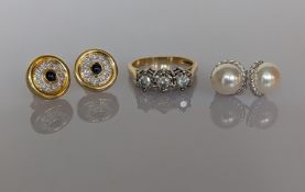 A pair of 18ct yellow gold sapphire and diamond earrings, stamped; a three-stone diamond ring