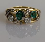 A vintage emerald and diamond dress ring on an 18ct yellow gold split shank