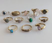 An assortment of twelve gem-set rings in white and yellow gold settings, all hallmarked 9ct