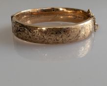 A vintage 9ct yellow gold hinged bangle with etched decoration, inscribed to inside, hallmarked