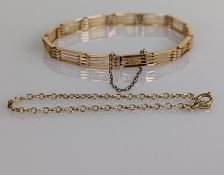 A rose gold gate-link bracelet with safety chain, stamped 15ct, 14g and another 