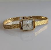 A mid-century ladies Longines dress watch with baton markers, 18ct gold case and fancy-link strap