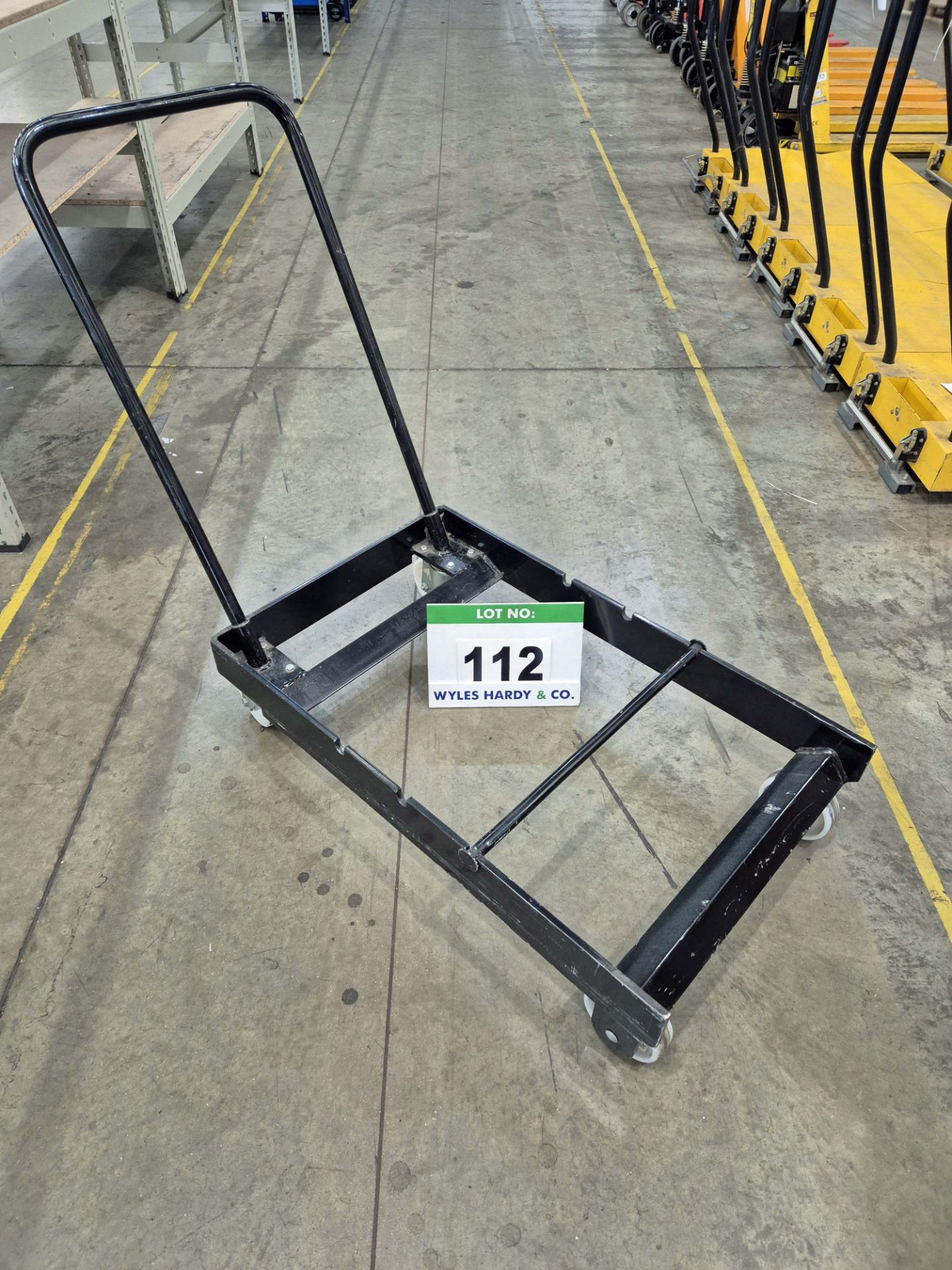 An Unbranded Black Steel Framed Manual Pedestrian Paper Roll Transportation Trolley