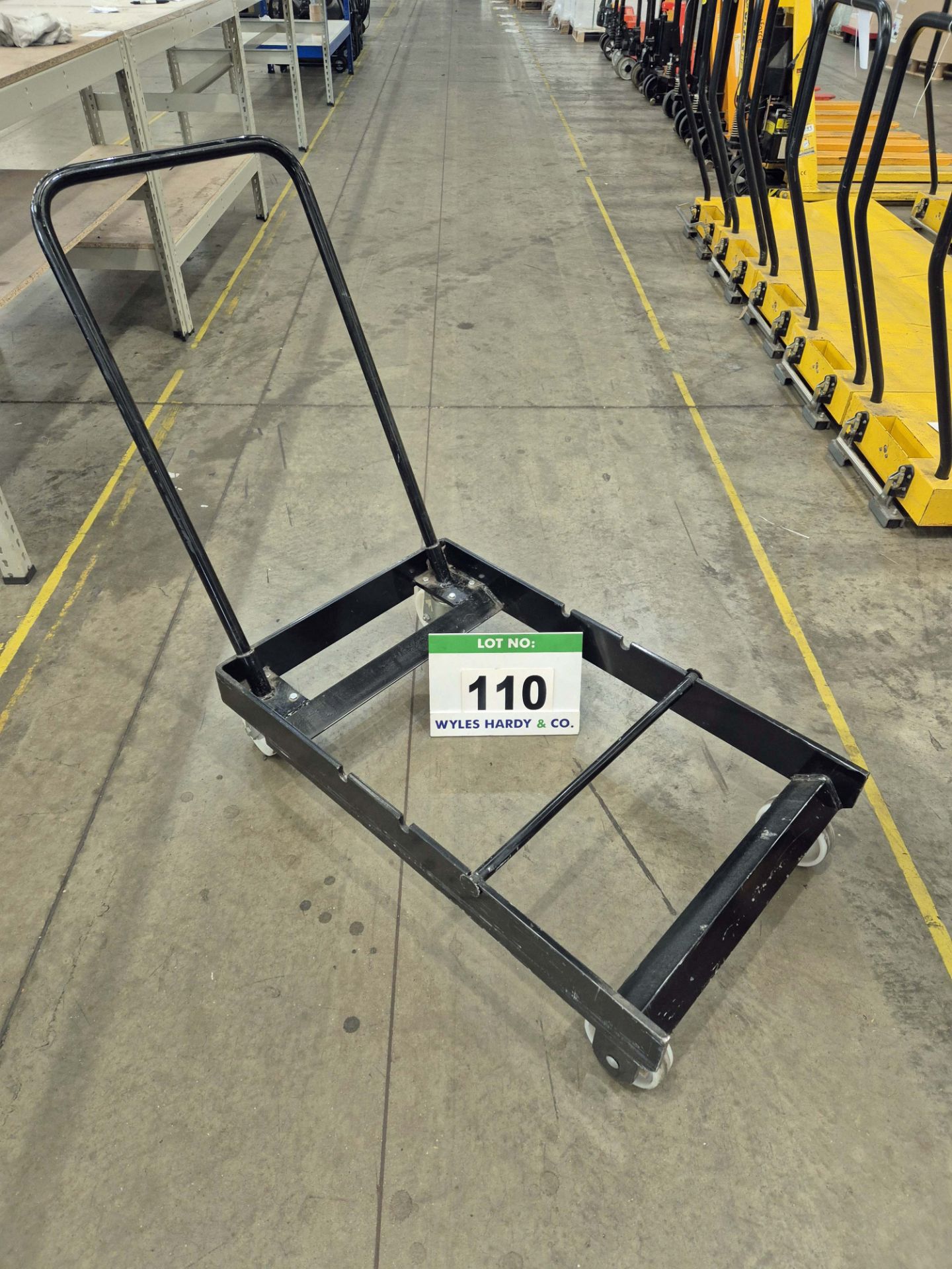 An Unbranded Black Steel Framed Manual Pedestrian Paper Roll Transportation Trolley