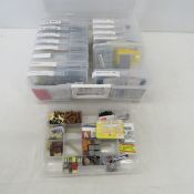 HO model train accessories in plastic organizers