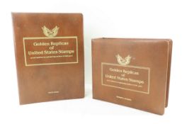 2 binders, golden replicas of US stamps