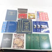 Partial coin books with some coins, empty books