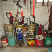 Large oil drums with pumps, oil cans and more