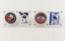 2 Autographed Hockey cards with pucks in displays