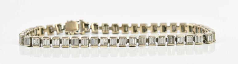 A white metal diamond set tennis bracelet, with baguette diamonds in a rub over setting, length