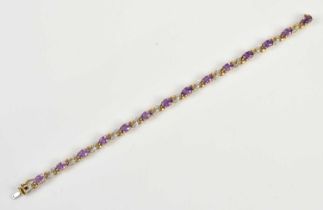 A yellow metal diamond and amethyst set tennis bracelet, stamped 375 to clasp, length 18.5cm, approx