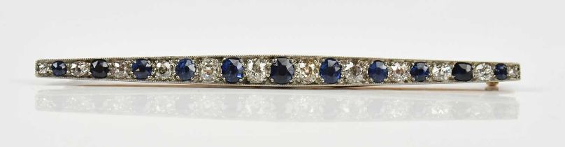 A yellow and white metal diamond and sapphire set bar brooch, with twelve diamonds and twelve