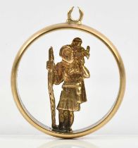 A 9ct yellow gold figure of St Christopher mounted in a yellow metal band, approx 3.8g.