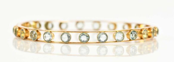 A Victorian yellow metal bangle set with twenty-five aquamarines, each approx 4.2mm diameter,