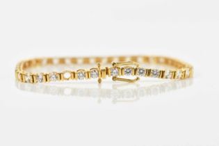 A yellow metal tennis bracelet, set with thirty-nine clear stones (one missing), stamped 18K CZ,