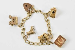 A yellow metal bracelet, set with five 9ct gold and yellow metal charms and a padlock clasp,