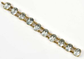 A Victorian gilt metal and aquamarine set ten stone bracelet, length 13.5cm, (af). Condition Report: