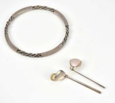GEORG JENSEN; a sterling silver bangle, model no. 17C, of twisted and plain bar form, and a pair