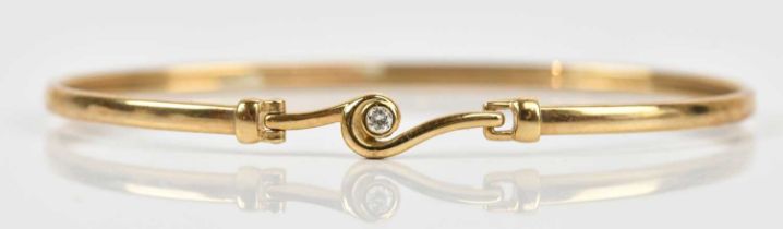 A 9ct yellow gold diamond set bangle, length 7cm, approx 3.7g, fitted in a Diamonds by Solar box.