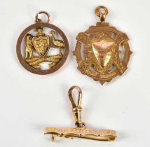 A 9ct yellow gold fob medal, Juvenile Champions dated 1922, a 9ct gold fob medal inscribed '