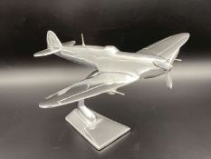 A CAST ALUMINIUM MODEL OF A SPITFIRE FIGHTER PLANE,