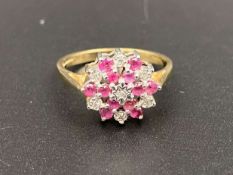 A Ruby and Diamond set flower head, 9ct gold ring