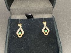 Pair of yellow metal and emerald earrings