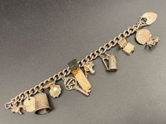 A white metal charm bracelet,&nbsp;