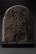 LARGE EGYPTIAN GRANITE FUNERARY STELA OF THE LECTOR-PRIEST BAKY AND HIS WIFE RUIU