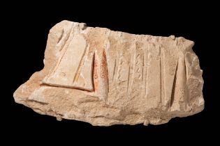 FRAGMENT OF A SUNK RELIEF DEPICTING THE PHARAOH AKHENATEN ADORING THE SOLAR DISC ATEN