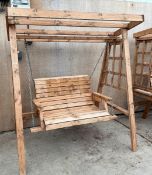 A WOODEN 2 SEATER SWING + VAT