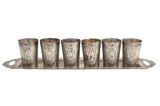 A SET OF SIX RUSSIAN WHITE METAL SHOT GLASSES ON AND TRAY Russia, circa 1900