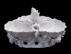 A Plymouth white triple scallop shell sweetmeat stand the rocky base and centre applied with shells,
