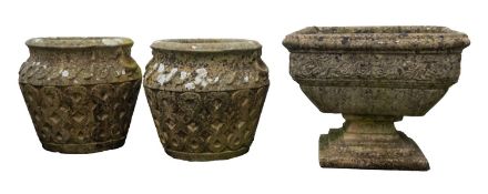A pair of stone composition garden urns, almost certainly Cotswold Studios Ltd.