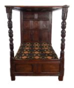 An oak half tester bed, elements 17th century and later; with panelled canopy,