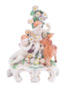 A Plymouth group of two putti with a goat the putti holding flowers, the goat standing below,