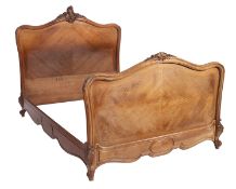 A 19th Century French walnut double bed in the rococo manner,
