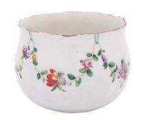 A Champion's Bristol finger bowl painted with a garland of flowers and foliage suspended from green