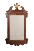 A walnut and carved wood wall mirror in the George I manner,