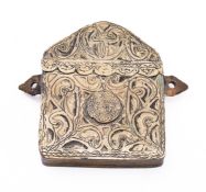 A Middle Eastern embossed brass Koran holder with inset coin, hinged top and suspension loops,