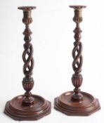 A pair of brass mounted mahogany candlesticks in George III style,