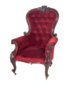 A Victorian carved mahogany armchair, with upholstery to match the previous lots,