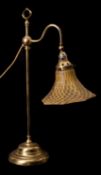 A brass and glass adjustable student's lamp in Arts & Crafts taste,