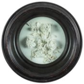 A Champion's Bristol white biscuit porcelain circular plaque applied with a ribbon tied bouquet of