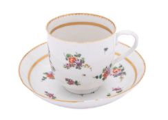 A Champion's Bristol coffee cup and saucer painted with scattered flower sprays and sprigs with