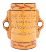 An Aller Vale Torquay pottery two handled cup decorated with stylised daisies and verso 'Torbay Nov